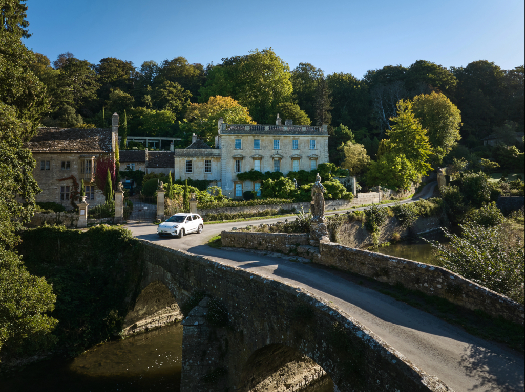 Beautiful view of Iford in England with a car about to cross the bridge